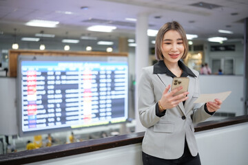 Fototapeta premium A woman is standing in front of a large screen with a red