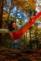 Relaxing in a Hammock in Autumn Forest