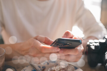 Social media marketing concept. Man hand using smartphone typing, chatting conversation in chat box icons pop up checking social media in cafe having a relaxing momen