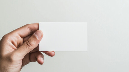 Obraz premium closeup of a hand holding a white, blank business card against a transparent background. Ideal for corporate business advertising and branding presentations, with ample space 