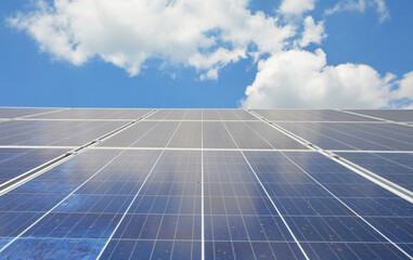 Solar panels with blue sky and white clouds as renewable green energy concept. Solar panels backgound with copy space.