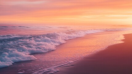 Soft wave crashing on the sandy beach at sunset.