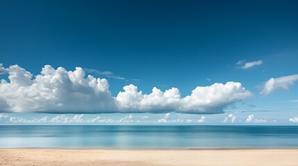 Fototapeta premium A serene beach landscape featuring tranquil waters, soft sand, and a clear blue sky adorned with fluffy white clouds. 