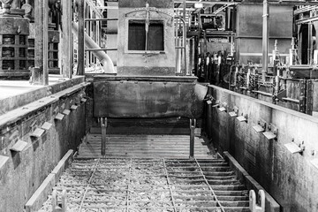Obraz premium Black and white photo of an old coal shaft in a disused industrial area