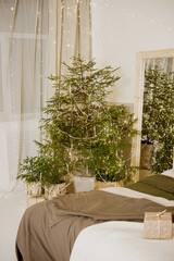 Interior bedrooms in Scandinavian style, decorated for the Christmas holidays. Live ate in the interior.