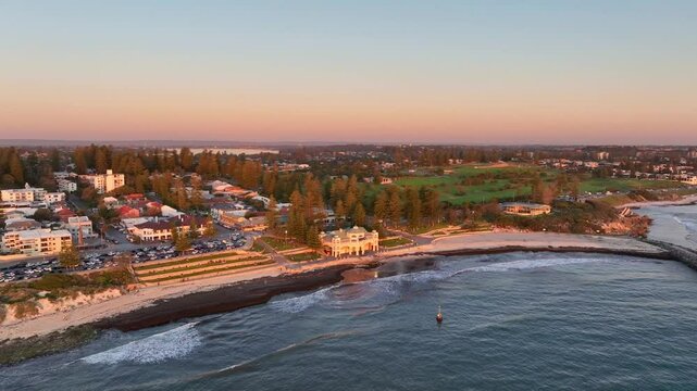 Wide drone shot of Perth's iconic Cottesloe Beach at sunset, Western Australia