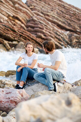 Casual Seaside Chat Between Two Friends at Sunset