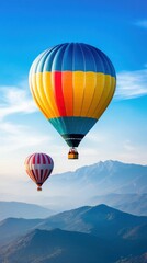 Fototapeta premium Colorful hot air balloons soaring over mountains at sunrise