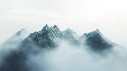 Misty mountain range with a bright sky and a hint of clouds.