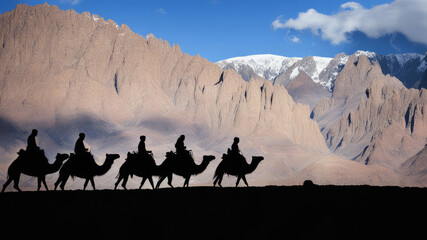 Silhouette of tourists riding camels and landscape in Ladakh