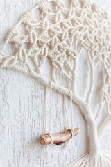 Close-up of hand made macrame texture pattern. ECO friendly modern knitting DIY natural decoration concept in the interior. Tree of life. Handmade 100% cotton. Female hobby..