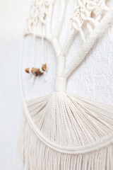 Close-up of hand made macrame texture pattern. ECO friendly modern knitting DIY natural decoration concept in the interior. Handmade 100% cotton, female hobby..