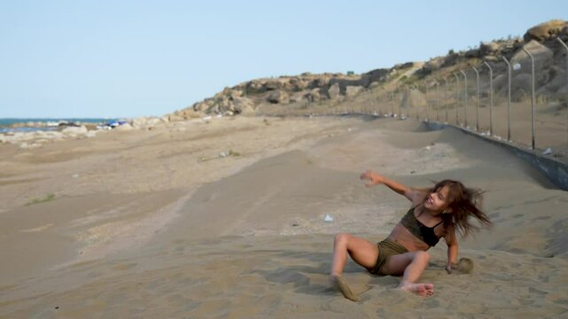 8 year old girl playing on the beach. Child girl enjoying sand on beach