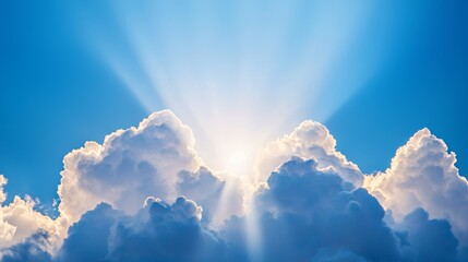 Fototapeta premium Radiant sunlight shining through fluffy clouds in a clear blue sky, showcasing the beauty of nature and tranquility