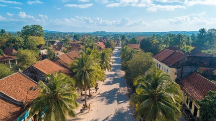 Bird's eye view of the historic French Quarter in Battambang, with colonial buildings, palm trees, and winding streets.
