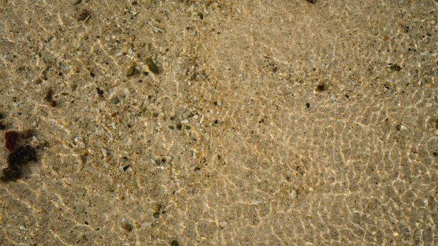 sand at the confluence of river and beach at geger beach 