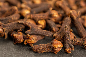 A close-up of aromatic cloves, highlighting the texture and rich color