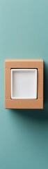 Fototapeta premium A minimalist square dish presented in a cardboard box, set against a soft turquoise background.
