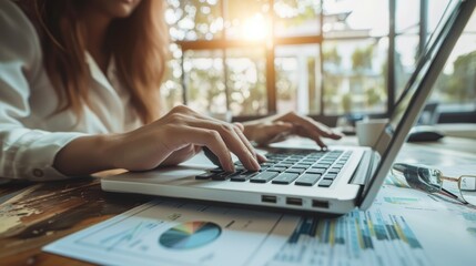 Close up businesswoman hand using calculator and working with laptop to calculate about finance accounting, market report with business document on office table