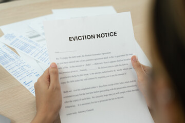 Fototapeta premium woman is stressed due to imminent seizure of assets, debts, financial problems, loans, guarantees document with the text eviction notice, debt, property, loan, agent, bankruptcy