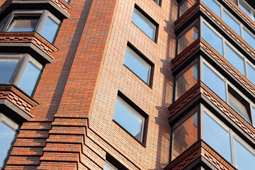 Naklejka premium modern building apartment down town red brick exterior facade good architecture landmark background view with foreshortening point view from below