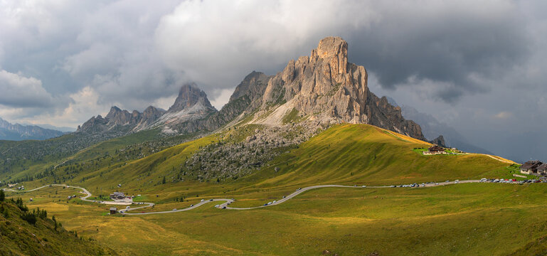 Panorama of Pass Giau with Monte Gusela at the background and curvy roads at its foot before the coming storm, Dolomites, Italy