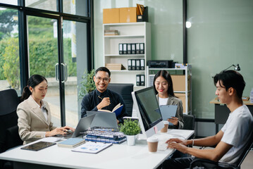 Group of Asian business meeting in planning design in creative business discussing work