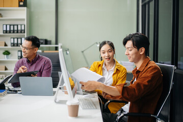 Business teamwork and collaboration among Asian professionals in a modern office