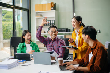 Business teamwork and collaboration among Asian professionals in a modern office