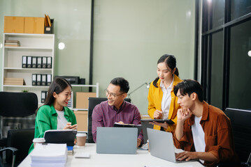 Business teamwork and collaboration among Asian professionals in a modern office