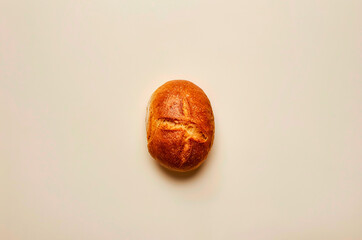 Minimalistic loaf of white bread with crust, top view