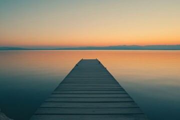 Fototapeta premium A tranquil wooden dock extends into a calm lake at sunset. Soft hues of orange and blue blend seamlessly in the sky. Perfect for relaxation and peace. Generative AI