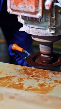 Worker cutting stone block. Industrial worker making horizontal cut with electric saw during align marble tiles. Vertical video