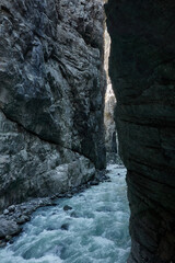 Hiking to the Gletscherschlucht glacier in Grindelwald, with imposing canyons, waterfalls and panoramic views of the valley. Swiss Alps