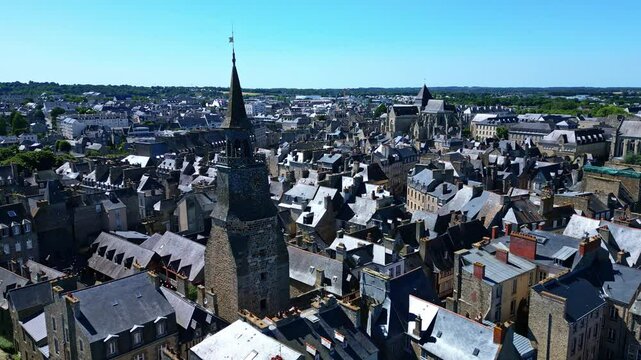 Clock tower or the Tour de l'Horloge and Saint-Malo church in background, Dinan, France. Aerial drone forward and sky for copy space