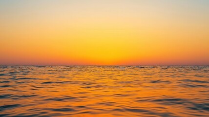 Obraz premium Golden sunrise over a calm ocean, symbolizing the dawn of a new day