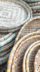 Obraz premium Traditional handmade bamboo trays stacked together, symbolizing Asian craftsmanship and sustainability