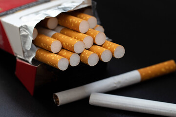 Cigarettes in a pack with a dark background