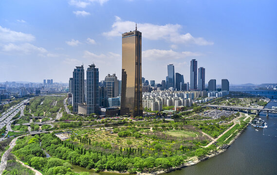 Yeouido, Yeongdeungpo-gu, Seoul, South Korea - April 18, 2021: Aerial view of Saetgang River and Han River Citizens Park with 63 Building and high-rise apartments in the background