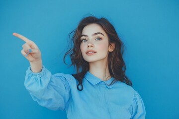 Fototapeta premium Photo portrait of attractive young woman point empty space dressed stylish blue clothes isolated on blue color background