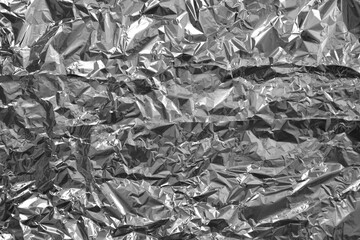 Processed collage of shiny metal silver gray foil crumpled packaging material texture