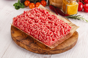 Raw minced beef meat over board