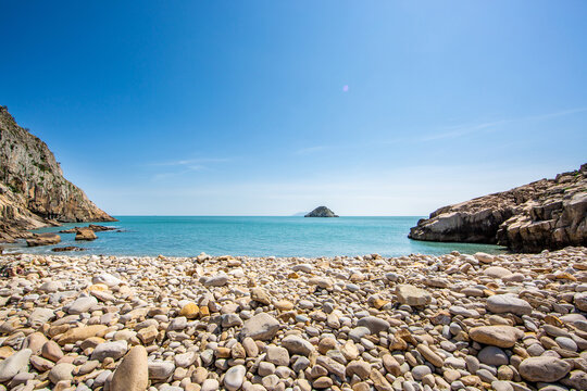 Pebbles at Mongdol Beach(Janggimi Beach) with an island on sea horizon at Cheongsando Island near Wando-gun, South Korea 
