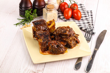 Prepared tasty beef ribs with sauce