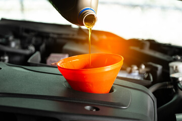 Refueling and pouring oil quality into the engine motor car Transmission and Maintenance Gear .Energy fuel concept