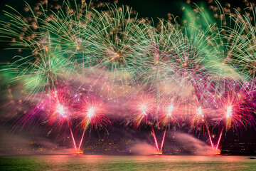 View of colorful fireworks display over the lake with city lights, Zurich, Switzerland.
