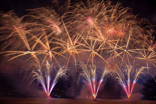 View of colorful fireworks display over the night sky and illuminated water, Zurich, Switzerland.