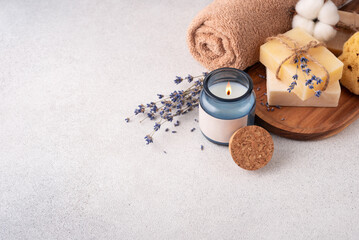 Bathroom items with crafted bars of soap, towel and aroma candle