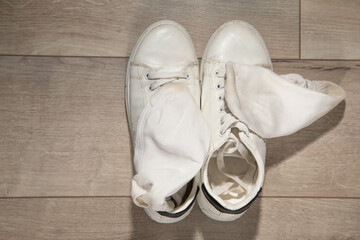 Dirty socks lying on laminate floor.