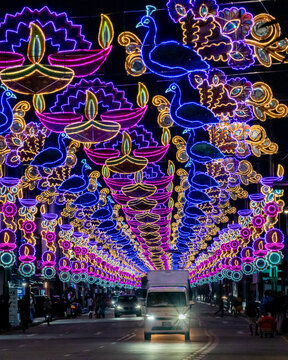 View of colourful Deepavali street lights and decorations with a vibrant crowd, Serangoon Road, Singapore.